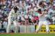 LONDON, ENGLAND - AUGUST 19: Ian Bell of England hits out watched by wicketkeeper Mahendra Singh Dhoni of India during day two of the 4th npower Test Match between England and India at The Kia Oval on August 19, 2011 in London, England. (Photo by Shaun