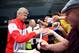 BOREHAMWOOD, ENGLAND - JULY 19: Arsenal manager Arsene Wenger signs autographs for fans as he arrives ahead of the pre season friendly match between Borehamwood and Arsenal at Meadow Park on July 19, 2014 in Borehamwood, England. (Photo by Jordan Mansfi