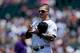 DENVER, CO - JULY 23: Brandon Barnes #1 of the Colorado Rockies plays paper, rock, scissors with a member of the Washington Nationals during a friendly standoff before the game started at Coors Field on July 23, 2014 in Denver, Colorado. (Photo by Justin
