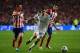 LISBON, PORTUGAL - MAY 24: Angel Di Maria of Real Madrid takes on Gabi (L) and Jose Sosa of Club Atletico de Madrid (R) during the UEFA Champions League Final between Real Madrid and Atletico de Madrid at Estadio da Luz on May 24, 2014 in Lisbon, Portuga
