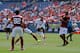 DENVER, CO - JULY 26: Wayne Rooney #10 of Manchester United shoots and scores pas Urby Emanuelson #82 and Seydou Keita #20 of AS Roma during the first half of an International Champions Cup match at Sports Authority Field at Mile High on July 26, 2014 in
