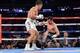 Jul 26, 2014; New York, NY, USA; Gennady Golovkin (white gloves) knocks out Daniel Geale (black gloves) during their middleweight championship bout at Madison Square Garden. Golovkin won via third round knockout. Mandatory Credit: Joe Camporeale-USA TODAY