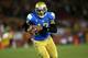 LOS ANGELES, CA - NOVEMBER 30: Quarterback Brett Hundley #17 of the UCLA Bruins carries on a 12 yard touchdown run in the third quarter against the USC Trojans at Los Angeles Coliseum on November 30, 2013 in Los Angeles, California. The Bruins won 35-14
