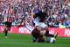 SUNDERLAND, ENGLAND - SEPTEMBER 29: Jose Enrique of Liverpool is tackled by Craig Gardner of Sunderland during the Barclays Premier League match between Sunderland and Liverpool at the Stadium of Light on September 29, 2013 in Sunderland, England. (Photo