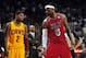 Feb 24, 2013; Miami, FL, USA; Cleveland Cavaliers point guard Kyrie Irving (left) looks over at Miami Heat small forward LeBron James (right) as Cleveland Cavaliers head coach Byron Scott (center) looks on during the second half at the American Airlines A