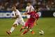 DALLAS, TX - JULY 29: Isco #23 of Real Madrid dribbles the ball past Radja Nainggolan #4 of AS Roma during a Guinness International Champions Cup 2014 game at Cotton Bowl on July 29, 2014 in Dallas, Texas. (Photo by Ronald Martinez/Getty Images)