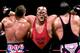 Vader clotheslines Bret Hart and The British Bulldog