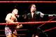 Undertaker looks to send Owen Hart's head into the turnbuckle.