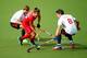 GLASGOW, SCOTLAND - JULY 31: Taylor Curran of Canada is challenged by Simon Mantell of England during the men's Preliminaries Pool B match between England and Canada at the Glasgow National Hockey Centre during day eight of the Glasgow 2014 Commonwealth