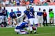 MIAMI GARDENS, FL - OCTOBER 20: (R) Dan Carpenter of the Buffalo Bills kicks a fiels goal in the last minute as (L) Brian Moorman #8 of the Buffalo Bills looks on against the Miami Dolphins at Sun Life Stadium on October 20, 2013 in Miami Gardens, Flori