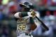 Jul 27, 2014; Arlington, TX, USA; Oakland Athletics left fielder Yoenis Cespedes (52) follows through for a two-run double against the Texas Rangers during the second inning of a baseball game at Globe Life Park in Arlington. Mandatory Credit: Jim Cowsert