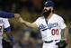 Jun 16, 2014; Los Angeles, CA, USA; Los Angeles Dodgers reliever Brian Wilson takes the ball from manager Don Mattingly (8) as he comes in to pitch in the eighth inning against the Colorado Rockies at Dodger Stadium. Mandatory Credit: Robert Hanashiro-USA