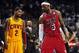 Feb 24, 2013; Miami, FL, USA; Cleveland Cavaliers point guard Kyrie Irving (left) looks over at Miami Heat small forward LeBron James (right) as Cleveland Cavaliers head coach Byron Scott (center) looks on during the second half at the American Airlines A