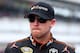 INDIANAPOLIS, IN - JULY 26: Denny Hamlin, driver of the #11 FedEx Express Toyota, looks on from the grid during qualifying for the NASCAR Sprint Cup Series Crown Royal Presents The John Wayne Walding 400 at the Brickyard Indianapolis Motor Speedway on Ju