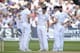 NOTTINGHAM, ENGLAND - JULY 09: England captain Alastair Cook speaks with bowlers Stuart Broad and James Anderson during day one of 1st Investec Test match between England and India at Trent Bridge on July 9, 2014 in Nottingham, England. (Photo by Gareth