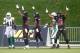 Dobson Collins (center) and teammates celebrate the successful onside kick recovery for a touchdown.