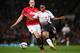 MANCHESTER, ENGLAND - SEPTEMBER 25: Phil Jones of Manchester United competes with Raheem Sterling of Liverpool during the Capital One Cup Third Round match betwen Manchester United and Liverpool at Old Trafford on September 25, 2013 in Manchester, Englan