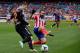 MADRID, SPAIN - FEBRUARY 15: Arda Turan (R) of Atletico de Madrid competes for the ball with Antonio Rukavina (L) of Real Valladolid CF during the La Liga match between Club Atletico de Madrid and Real Valladolid CF at Vicente Calderon Stadium on Februar