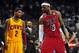 Feb 24, 2013; Miami, FL, USA; Cleveland Cavaliers point guard Kyrie Irving (left) looks over at Miami Heat small forward LeBron James (right) as Cleveland Cavaliers head coach Byron Scott (center) looks on during the second half at the American Airlines A