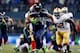 SEATTLE, WA - JANUARY 19: Running back Marshawn Lynch #24 of the Seattle Seahawks carries the ball against the San Francisco 49ers during the 2014 NFC Championship at CenturyLink Field on January 19, 2014 in Seattle, Washington. (Photo by Jonathan Ferre