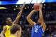 Mar 30, 2014; Indianapolis, IN, USA; Kentucky Wildcats guard Aaron Harrison (2) shoots and makes the game-winning three point shot over Michigan Wolverines guard Caris LeVert (left) in the second half in the finals of the midwest regional of the 2014 NCAA