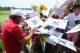 LOUISVILLE, KY - AUGUST 05: Phil Mickelson of the United States signs his autograph for fans during a practice round prior to the start of the 96th PGA Championship at Valhalla Golf Club on August 5, 2014 in Louisville, Kentucky. (Photo by Andy Lyons/Ge
