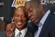 Jul 29, 2014; El Segundo, CA, USA; Byron Scott (left) is embraced by Magic Johnson at a press conference to introduce Scott as Los Angeles Lakers coach at Toyota Sports Center. Mandatory Credit: Kirby Lee-USA TODAY Sports