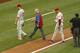 WASHINGTON, DC - JULY 31: Cliff Lee #33 of the Philadelphia Phillies is trailed by team personnel and manager Ryne Sandberg #23 as he leaves the field with an apparent injury during the third inning against the Washington Nationals at Nationals Park on J