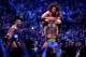 Batista powerbombs Daniel Bryan as Randy Orton waits to strike.