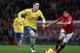 MANCHESTER, ENGLAND - NOVEMBER 10: Shinji Kagawa of Manchester United competes with Thomas Vermaelen of Arsenal during the Barclays Premier League match between Manchester United and Arsenal at Old Trafford on November 10, 2013 in Manchester, England.