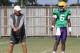 LSU offensive coordinator Cam Cameron (left) works with quarterback Brandon Harris (right)