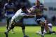 ST HELENS, ENGLAND - AUGUST 09: Rob Burrow of Leeds Rhinos in action with Ryan Atkins of Warrington Wolves during the Tetley's Challenge Cup Semi Final match between Leeds Rhinos and Warrington Wolves at Langtree Park on August 09, 2014 in St Helens, Engl