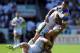 ST HELENS, ENGLAND - AUGUST 09: Joel Moon of Leeds Rhinos is tackled by Ashley Westwood and Chris Bridge of Warrington Wolves during the Tetley's Challenge Cup Semi Final match between Leeds Rhinos and Warrington Wolves at Langtree Park on August 09, 2014