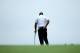 LOUISVILLE, KY - AUGUST 08: Tiger Woods of the United States rubs his back before hitting his second shot on the 17th hole during the second round of the 96th PGA Championship at Valhalla Golf Club on August 8, 2014 in Louisville, Kentucky. (Photo by An