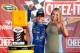 WATKINS GLEN, NY - AUGUST 10: AJ Allmendinger, driver of the #47 Scott Products Chevrolet, poses with girlfriend Tara Lea in Victory Lane after winning the NASCAR Sprint Cup Series Cheez-It 355 at Watkins Glen International on August 10, 2014 in Watkins