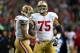 SEATTLE, WA - JANUARY 19: (R-L) Guard Alex Boone #75 smiles alongisde quarterback Colin Kaepernick #7 of the San Francisco 49ers in the first half against the Seattle Seahawks during the 2014 NFC Championship at CenturyLink Field on January 19, 2014 in S