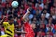 LIVERPOOL, ENGLAND - AUGUST 10: Dejan Lovren (R) of Liverpool and Pierre Emerick Aubameyang (L) of Borussia Dortmund contest a header during the Pre Season Friendly match between Liverpool and Borussia Dortmund at Anfield on August 10, 2014 in Liverpool,
