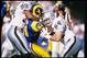 13 Nov 1994: Wide receiver Troy Drayton of the Los Angeles Rams gets tackled by a pair of Los Angeles Raiders players during a game at Anaheim Stadium in Anaheim, California. The Raiders won the game, 20-17. Mandatory Credit: Al Bello /Allsport