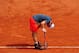 PARIS, FRANCE - MAY 31: Andy Murray of Great Britain doubles up as he struggles with a back problem during his men's singles second round match against Jarkko Nieminen of Finland during day five of the French Open at Roland Garros on May 31, 2012 in Pari