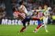 LISBON, PORTUGAL - MAY 24: Raul Garcia of Club Atletico de Madrid and Sami Khedira of Real Madrid battle for the ball during the UEFA Champions League Final between Real Madrid and Atletico de Madrid at Estadio da Luz on May 24, 2014 in Lisbon, Portugal.