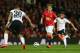 MANCHESTER, ENGLAND - AUGUST 12: Adnan Januzaj of Manchester United attempts to move past Nicolas Otamendi of Valencia during the Pre Season Friendly match between Manchester United and Valencia at Old Trafford on August 12, 2014 in Manchester, England.