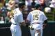 OAKLAND, CA - AUGUST 02: Jonny Gomes #15 of the Oakland Athletics is congratulated by Josh Reddick #16 after Gomes scored in the bottom of the fifth inning against the Kansas City Royals at O.co Coliseum on August 2, 2014 in Oakland, California. (Photo