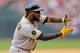 DENVER, CO - JULY 27: Josh Harrison #5 of the Pittsburgh Pirates celebrates towards the dugout after stealing second base and advancing to third base in a run-down during the sixth inning against the Colorado Rockies at Coors Field on July 27, 2014 in De