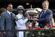 Trainer Bill Mott (right) hoisting 2010 Belmont Stakes trophy.