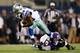 ARLINGTON, TX - AUGUST 16: Ryan Williams #34 of the Dallas Cowboys breaks the tackle attempt by Derrick Hopkins #78 of the Baltimore Ravens in the second half of their preseason game at AT&T Stadium on August 16, 2014 in Arlington, Texas. (Photo by Tom