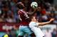 LONDON, ENGLAND - AUGUST 16: Eric Dier of Tottenham Hotspur is beaten to the ball in the air by Carlton Cole of West Ham during the Barclays Premier League match between West Ham United and Tottenham Hotspur at Boleyn Ground on August 16, 2014 in London,