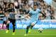 NEWCASTLE UPON TYNE, ENGLAND - AUGUST 17: Stevan Jovetic of Manchester City is pursued by Fabricio Coloccini of Newcastle during the Barclays Premier League match between Newcastle United and Manchester City at St James' Park on August 17, 2014 in Newcas