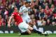 MANCHESTER, ENGLAND - AUGUST 16: Phil Jones of Manchester United tackles Jefferson Montero of Swansea City during the Barclays Premier League match between Manchester United and Swansea City at Old Trafford on August 16, 2014 in Manchester, England. (Ph