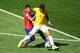 BELO HORIZONTE, BRAZIL - JUNE 28: Eduardo Vargas of Chile challenges Thiago Silva of Brazil during the 2014 FIFA World Cup Brazil round of 16 match between Brazil and Chile at Estadio Mineirao on June 28, 2014 in Belo Horizonte, Brazil. (Photo by Ian Wa