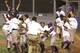Harlem walks off on its way to Williamsport. Julian (left, helmet) scored the game-winning run. His father, Morris, raises his arms in the background.
